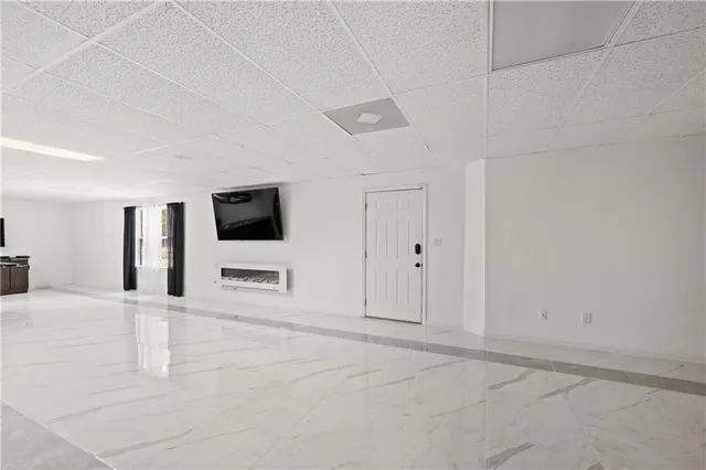 a view of a hallway with wooden cabinet