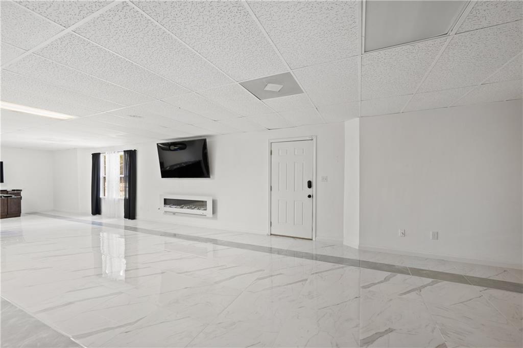 201 Nina Circle Locust Grove, GA 30248 - Photo 37 of 48 a view of a livingroom with an empty space and a garage