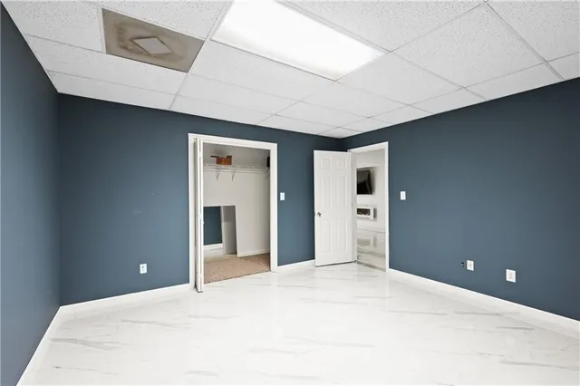 a hall with a sink and a mirror