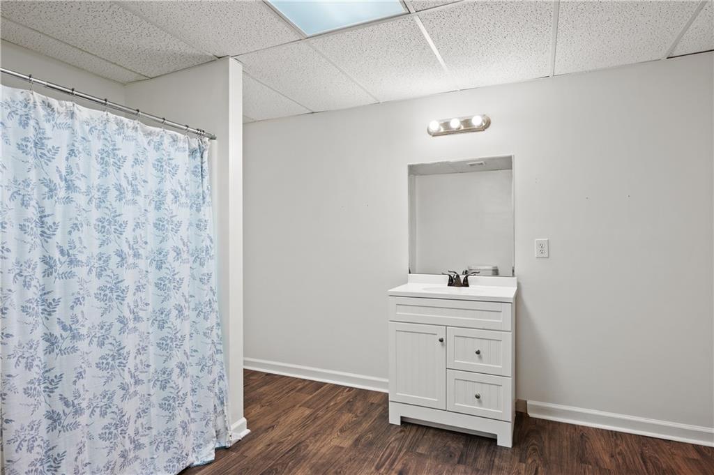 201 Nina Circle Locust Grove, GA 30248 - Photo 42 of 48 a bathroom with a sink a light fixture and a mirror