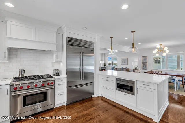a kitchen with cabinets and steel stainless steel appliances