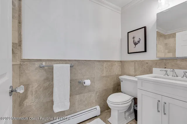 a bathroom with a toilet sink and mirror