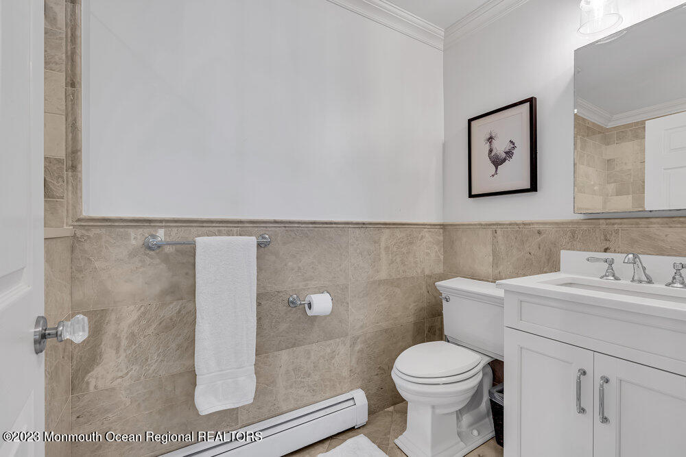 1609 Ocean Avenue Spring Lake, NJ 07762 - Photo 19 of 30 a bathroom with a toilet sink and mirror