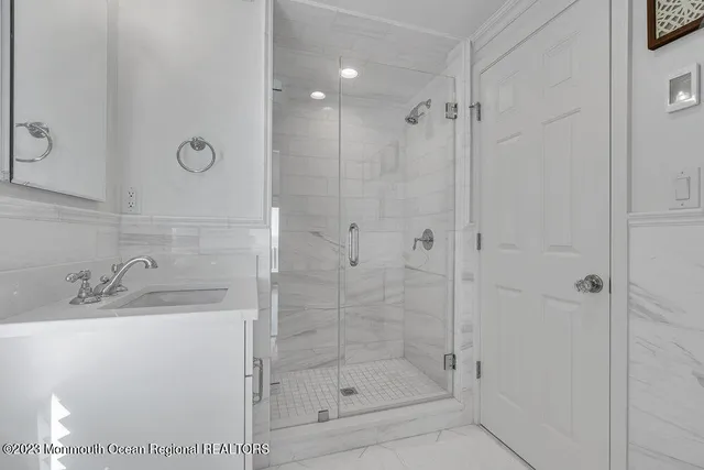 a bathroom with a shower and a sink