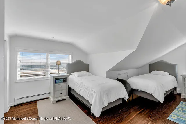 a bedroom with two beds and a window