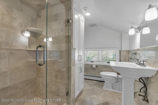 a bathroom with a sink toilet a shower and a mirror