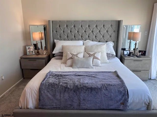 a bed sitting in a bedroom and lamp