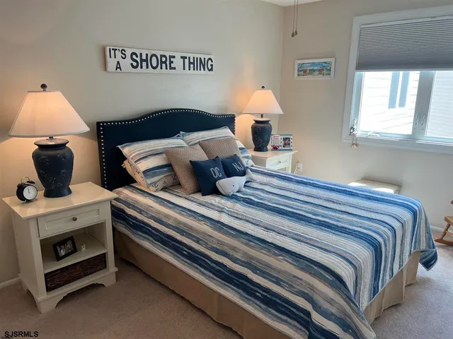 a bedroom with a bed and a lamp on table