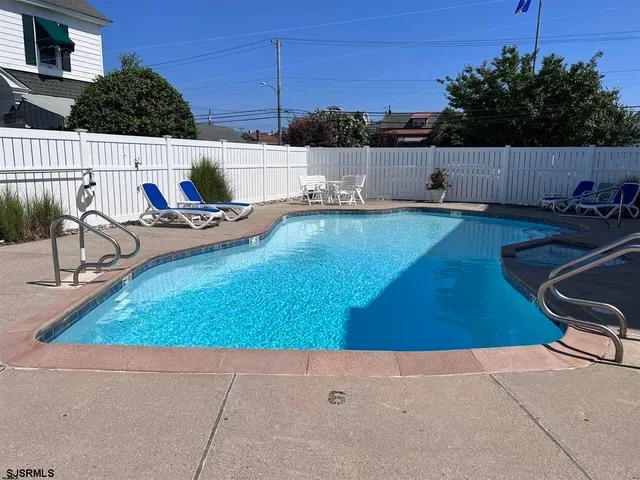 a roof deck with table and chairs