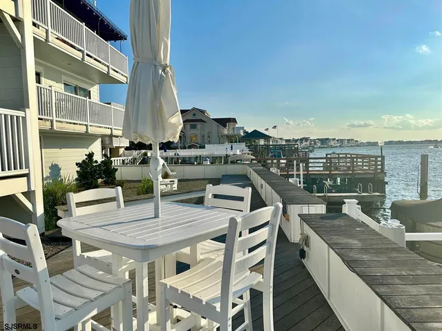 a view of a terrace with dining table and chairs