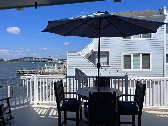 a view of a roof deck with table and chairs