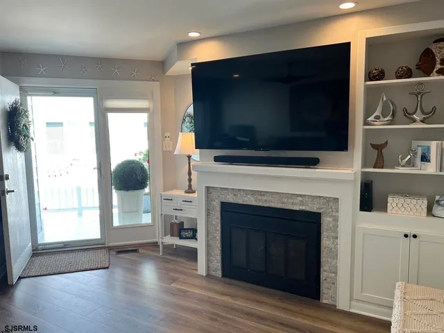 a living room with a fireplace and a flat screen tv