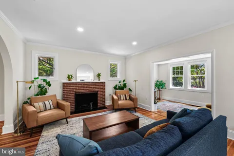 a living room with furniture and a book shelf