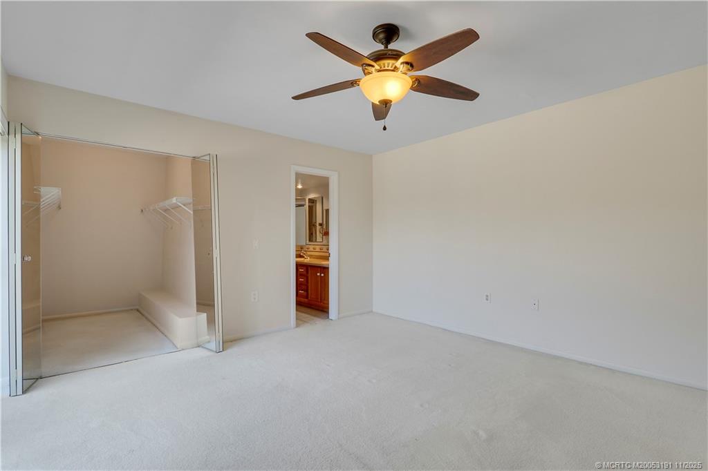 5662 Southeast Windsong Lane, Unit 408 Stuart, FL 34997 - Photo 23 of 35 an empty room with a window and a ceiling fan