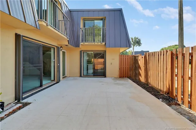 a view of a house with a wooden fence