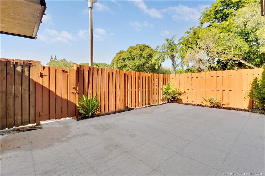 5662 Southeast Windsong Lane, Unit 408 Stuart, FL 34997 - Photo 35 of 35 a view of balcony with wooden fence