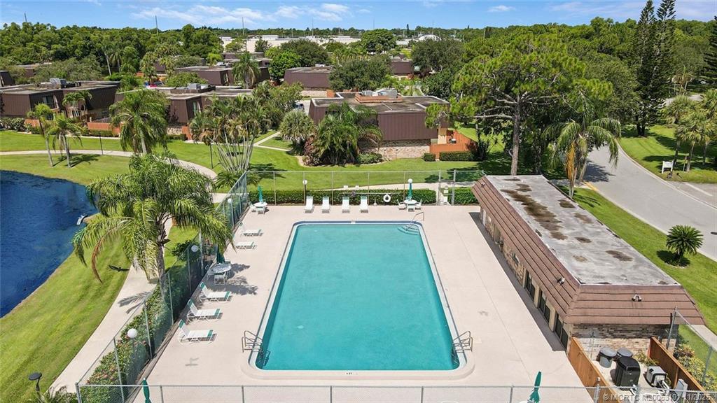 5662 Southeast Windsong Lane, Unit 408 Stuart, FL 34997 - Photo 4 of 35 a view of a swimming pool with a yard