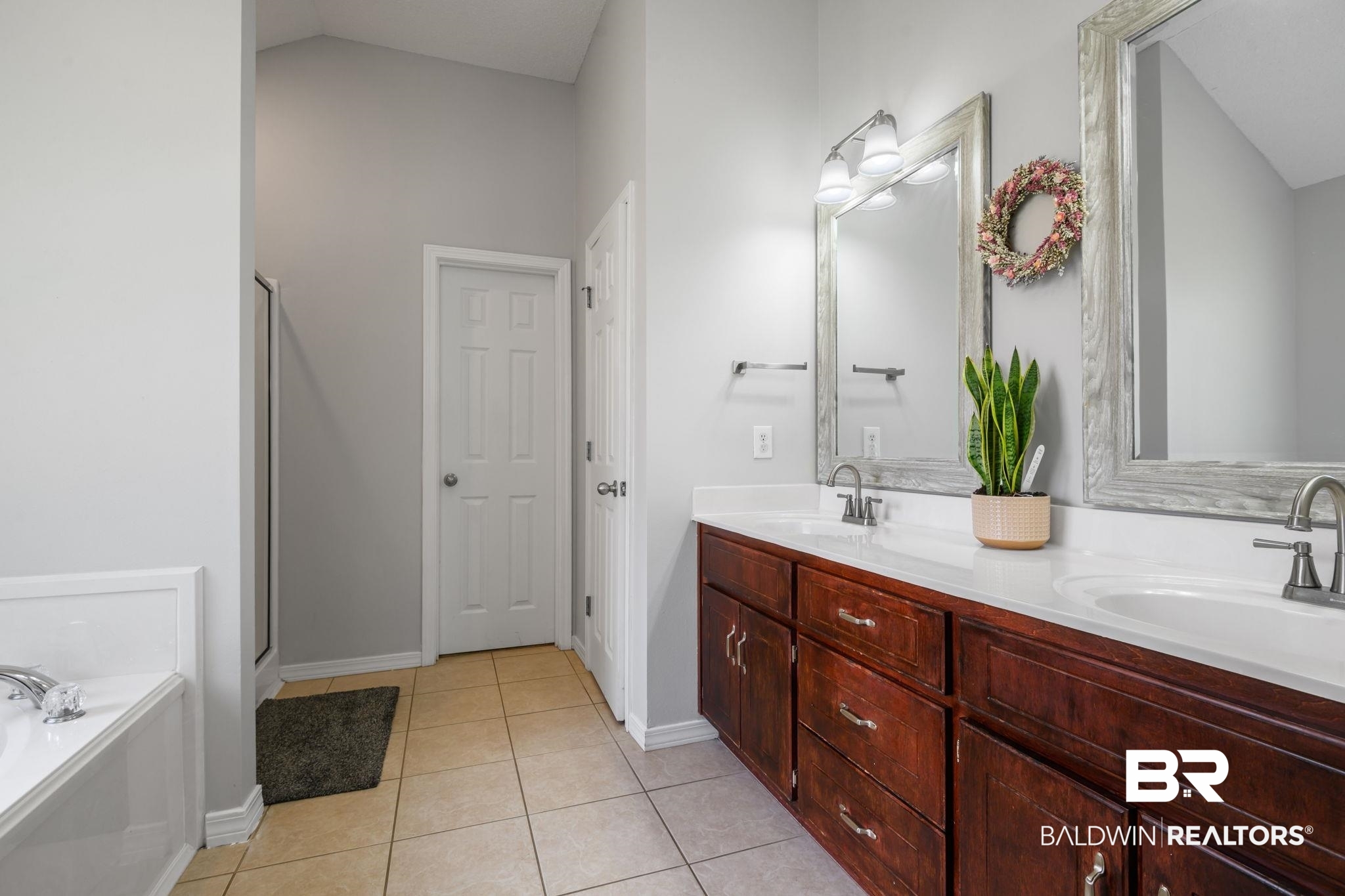 9422 Labrador Run South Mobile, AL 36695 - Photo 23 of 36 Double vanity with rich wood-finish cabinetry and white countertops