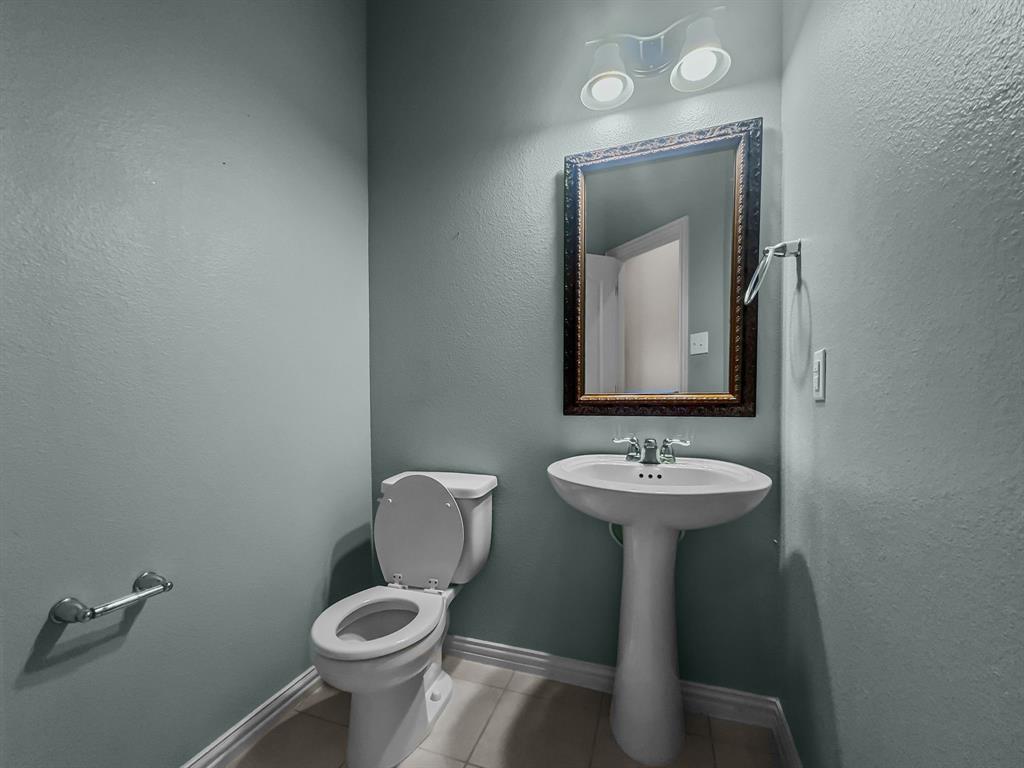 3205 Ridgeway Drive McKinney, TX 75071 - Photo 21 of 27 a bathroom with a toilet sink and mirror