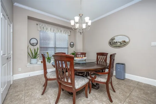 a view of a dining room with furniture and a chandelier