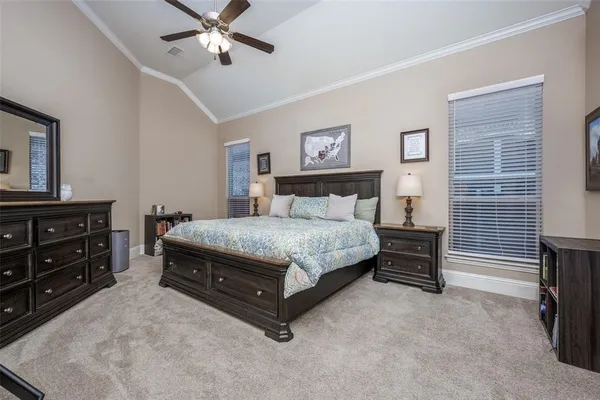 a bedroom with a bed dresser and a window