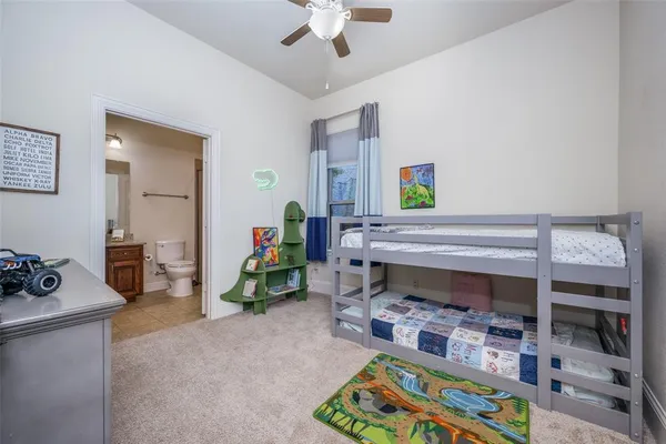 a living room with furniture and a baby crib