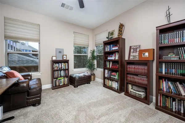 a living room with furniture and a book shelf