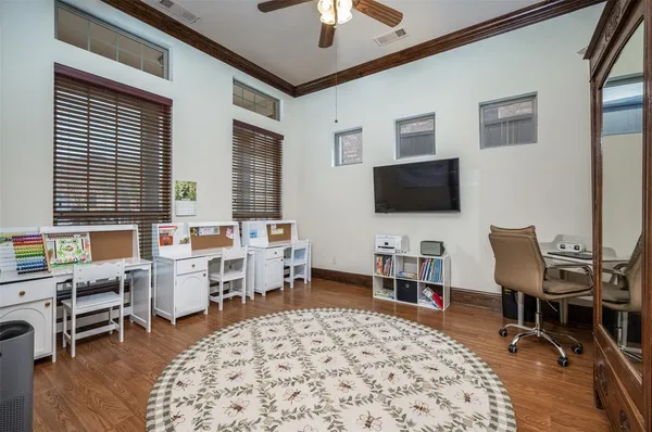 a view of a livingroom with workspace and a window