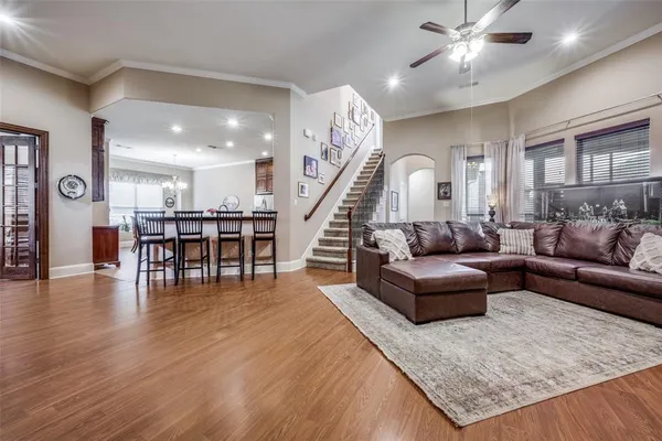 a living room with furniture and wooden floor
