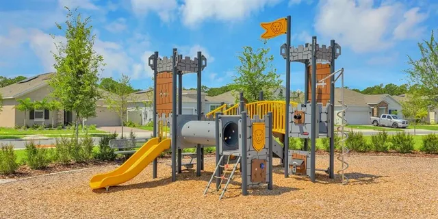 a view of a park with swings and slides