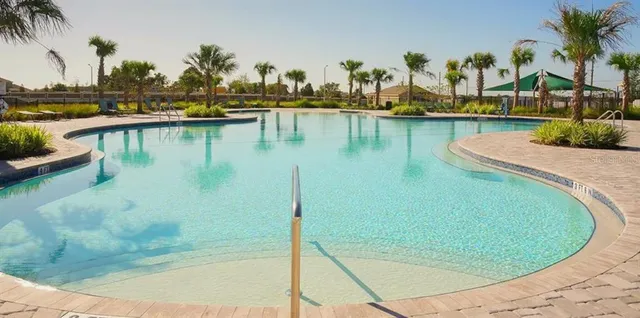 a view of a lake with boats and trees in the background