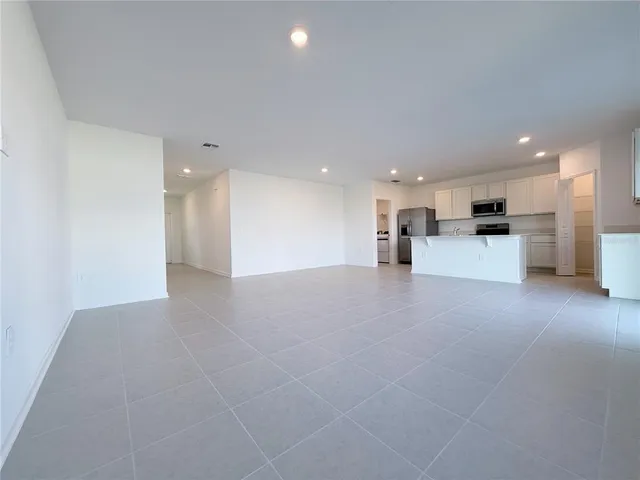 a view of a kitchen with a sink and a stove top oven