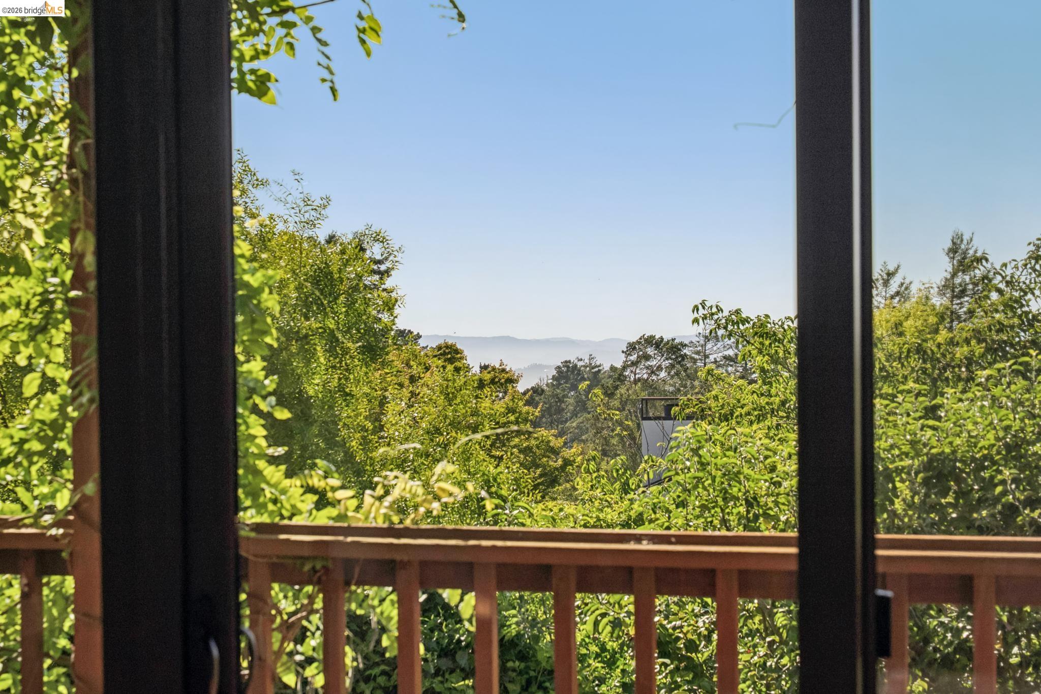 576 Vistamont Avenue Berkeley, CA 94708 - Photo 17 of 33 Sliding glass doors opening to an exterior wood deck with a natural wood railing