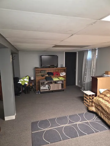 a bed sitting in a room next to a window