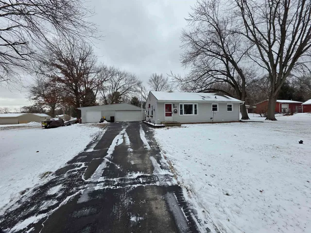 a view of a yard with snow on the road