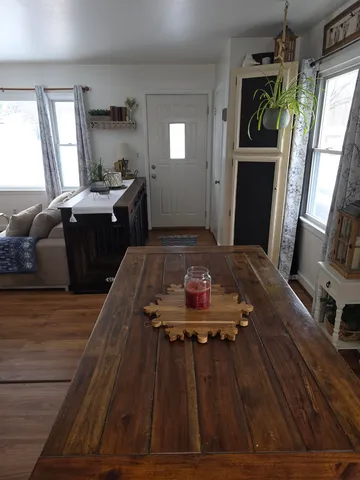 a large bedroom with a bed and wooden floor