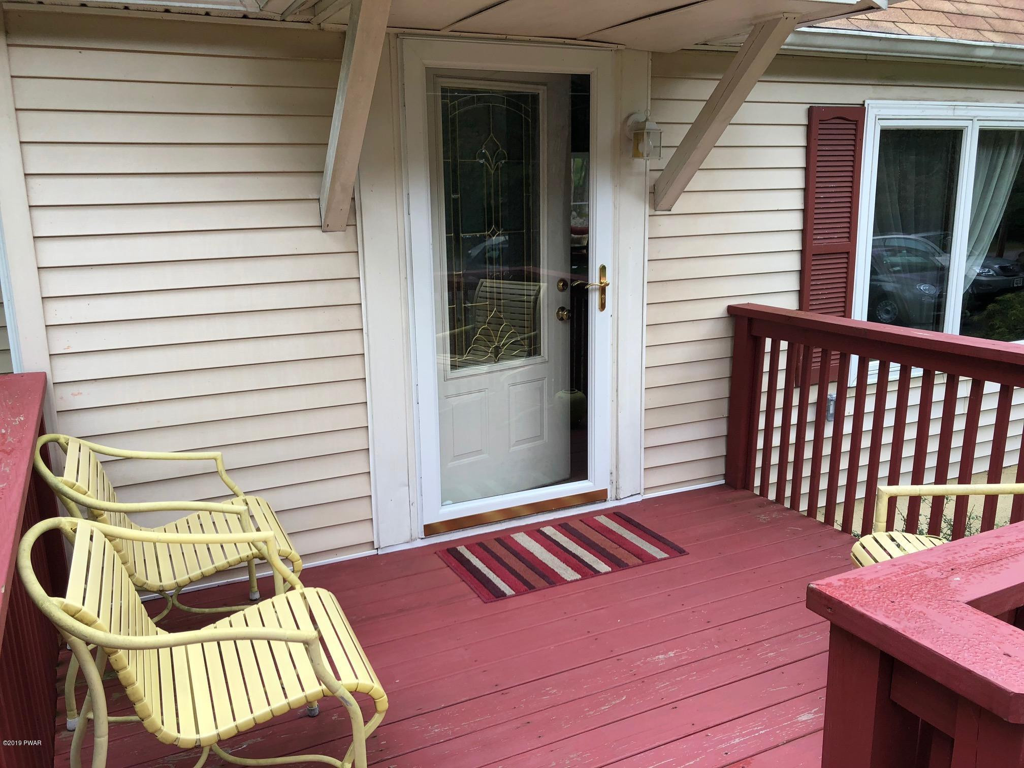 176 Heather Hill Road Dingmans Ferry, PA 18328 - Photo 2 of 32 a view of a two chairs in the balcony