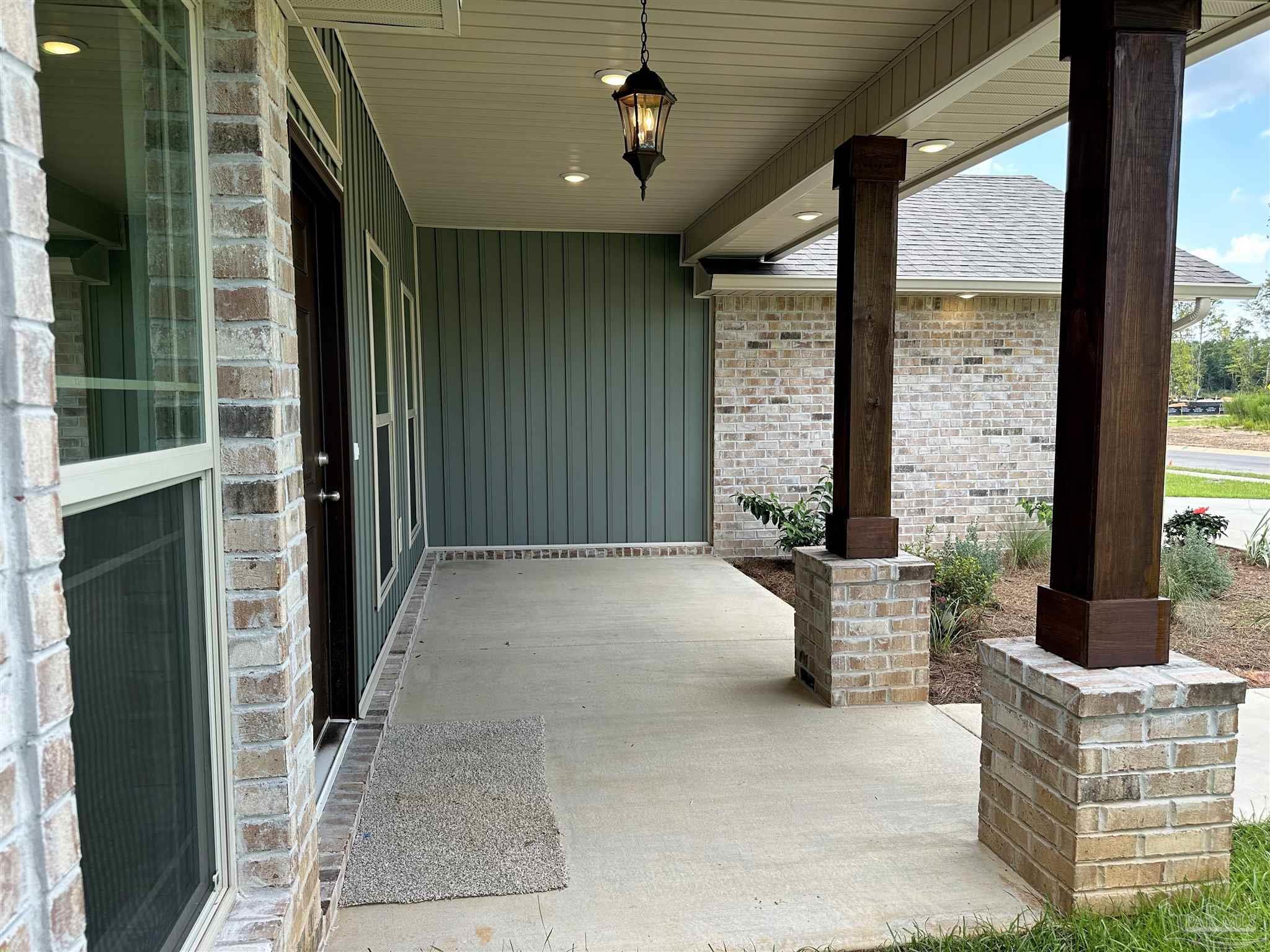 5231 Wahoo Road Milton, FL 32583 - Photo 4 of 14 a building outdoor space with patio furniture and potted plants