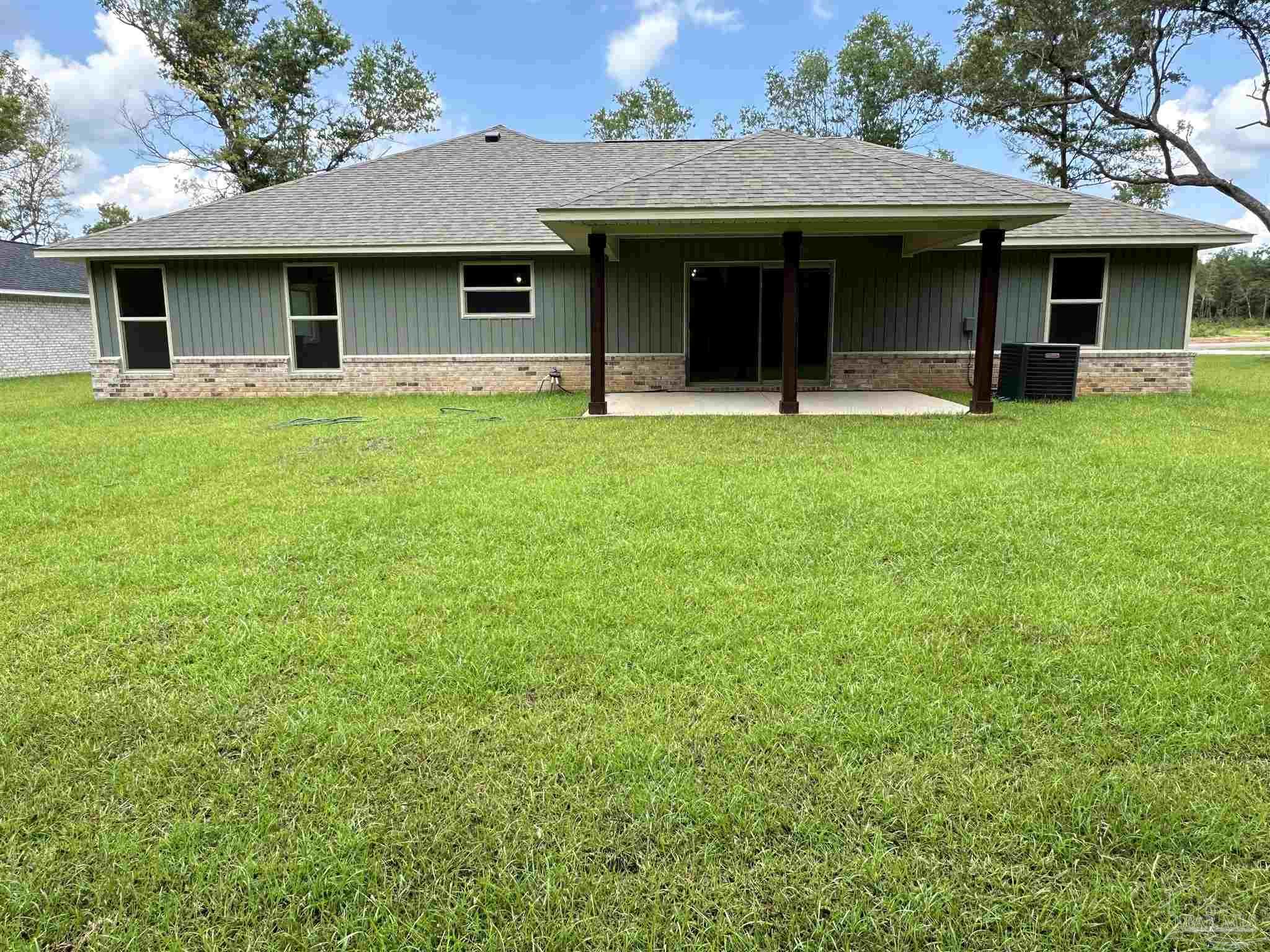 5231 Wahoo Road Milton, FL 32583 - Photo 6 of 14 a front view of a house with garden