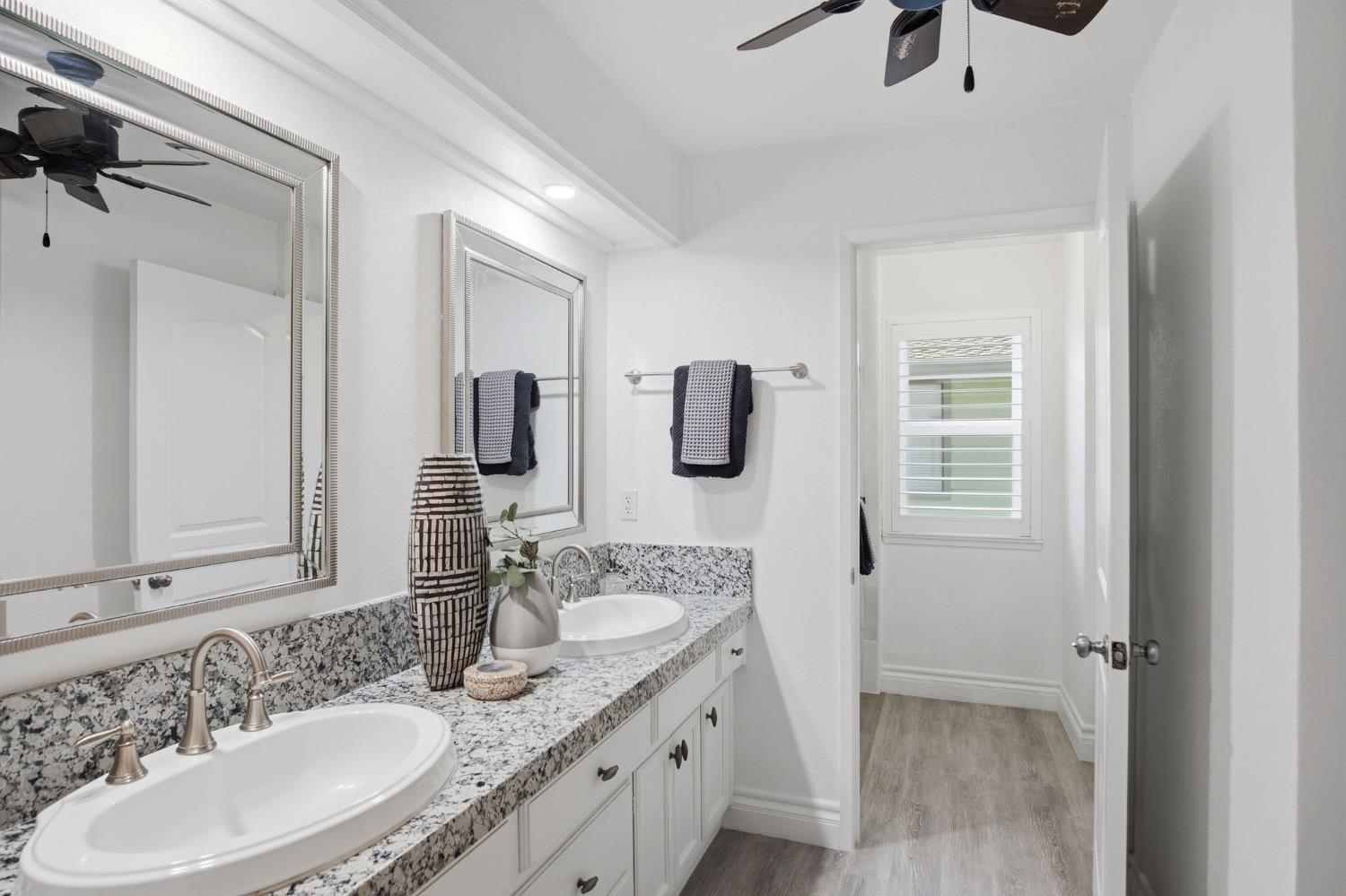 10401 Golf Link Road Turlock, CA 95380 - Photo 32 of 63 a bathroom with a granite countertop sink and a mirror