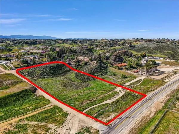 an aerial view of a golf course with a lake view