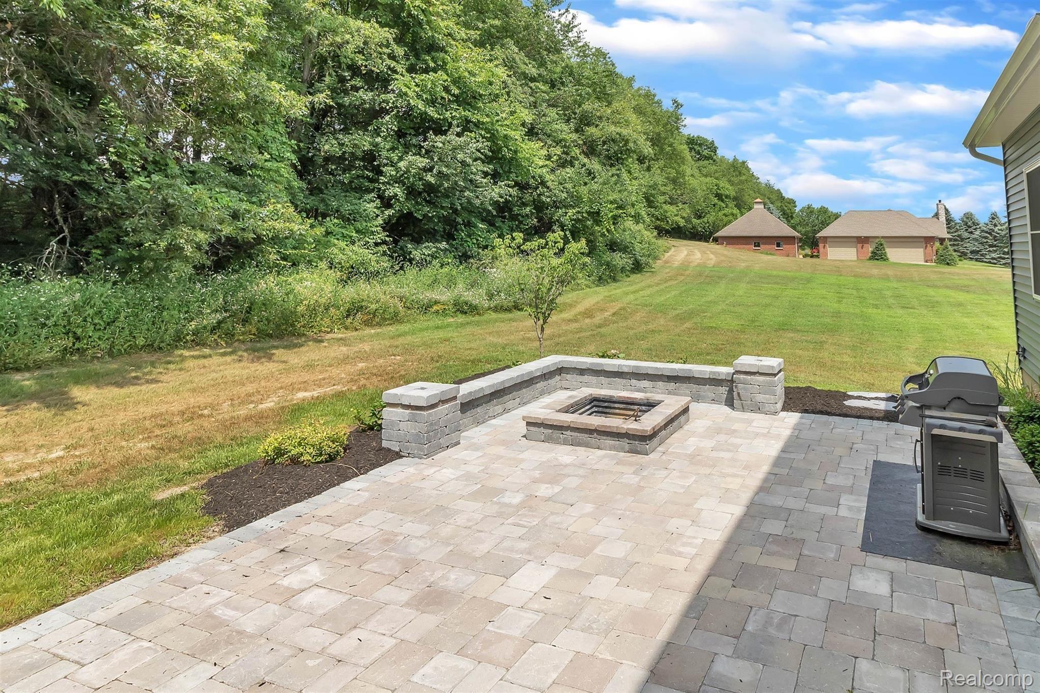 860 North Hacker Road Howell, MI 48843 - Photo 29 of 53 Custom Built Brick Patio with Firepit