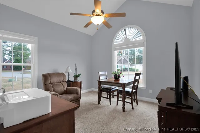 a dining room with furniture a livingroom and a large window