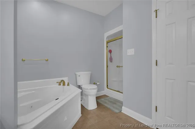 a bathroom with a bathtub and toilet