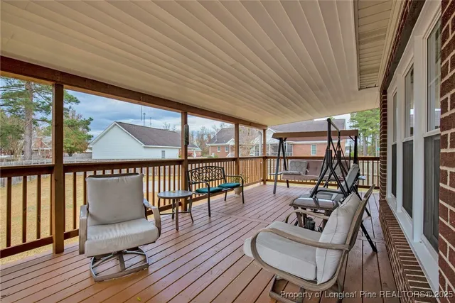 a living room with furniture floor to ceiling window and wooden floor
