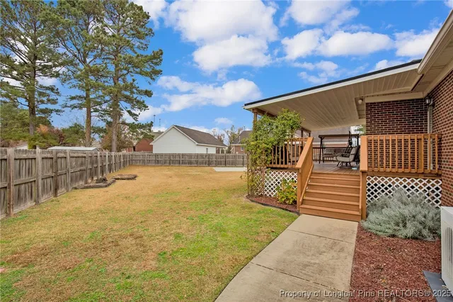 a view of house with backyard and tree