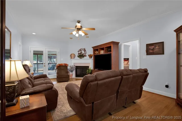 a living room with furniture a flat screen tv and a fireplace