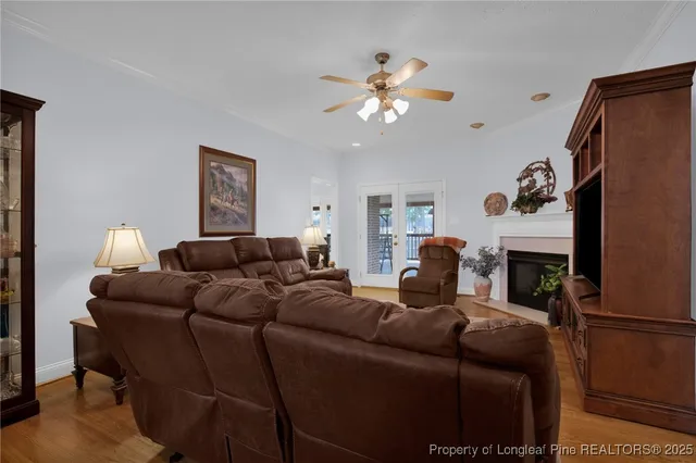 a living room with furniture a fireplace and a flat screen tv