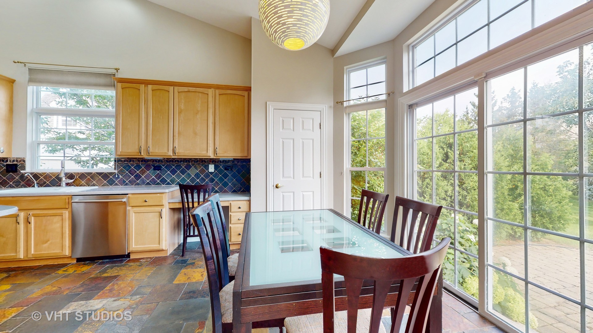 305 Saddle Lane Fox River Grove, IL 60021 - Photo 18 of 55 a view of a dining room with furniture a chandelier and wooden floor