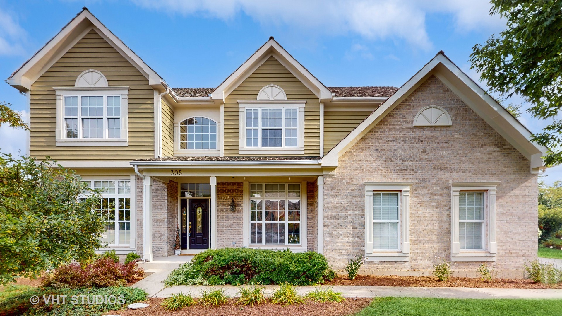 305 Saddle Lane Fox River Grove, IL 60021 - Photo 2 of 55 front view of brick house with a yard